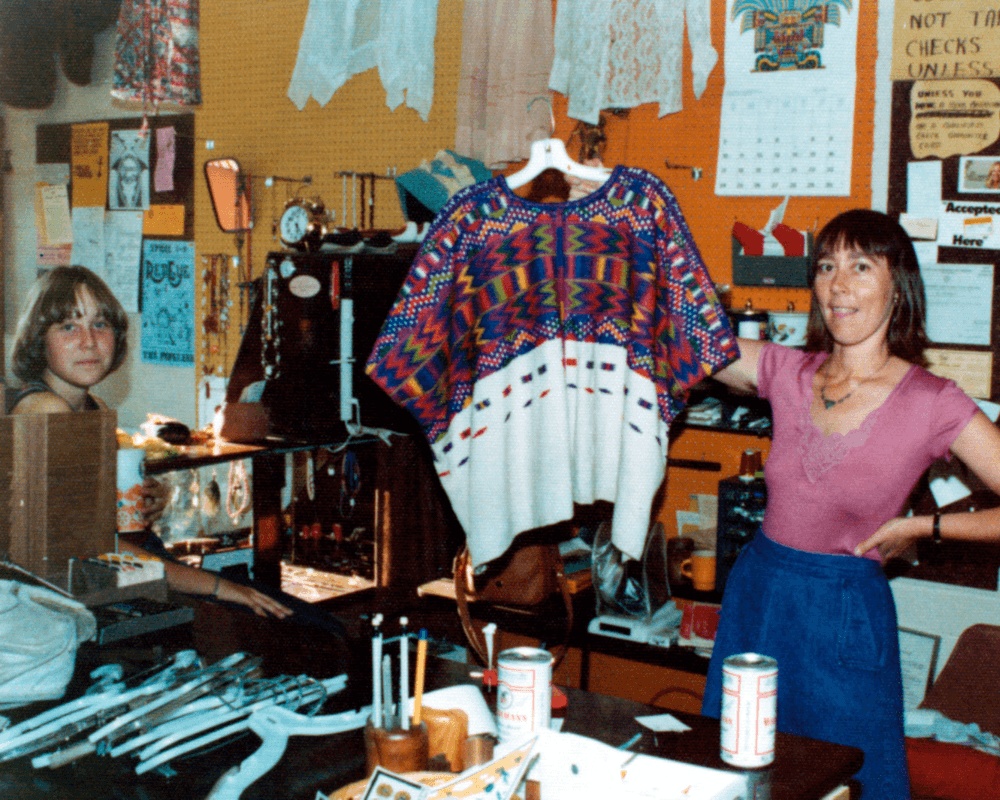 An archival photograph of Kerstin Block holding a brightly patterned garment inside Buffalo Exchange