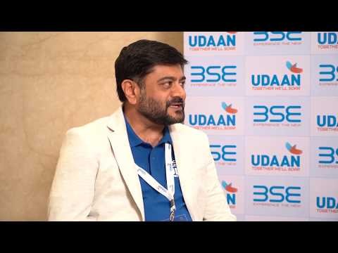 Ketan Shah in a light blazer speaking at the BSE UDAAN 2019 conference