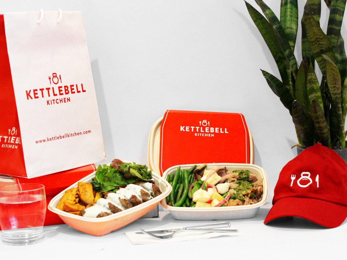 Kettlebell Kitchen branded bag, cap and two prepared meals displayed together