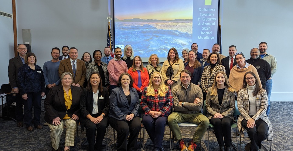 Kevin Allan seated with the Dutchess Tourism staff and board at a 2024 meeting