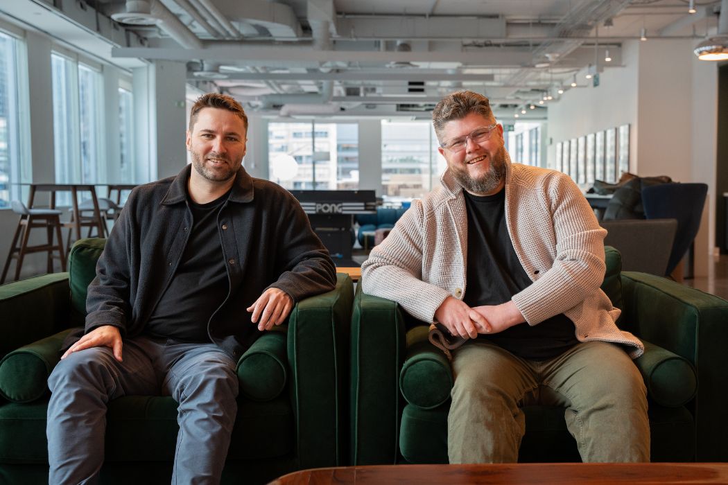 Phoenix co-founders Kevin Bache and Gavin Thompson seated in green armchairs in their office