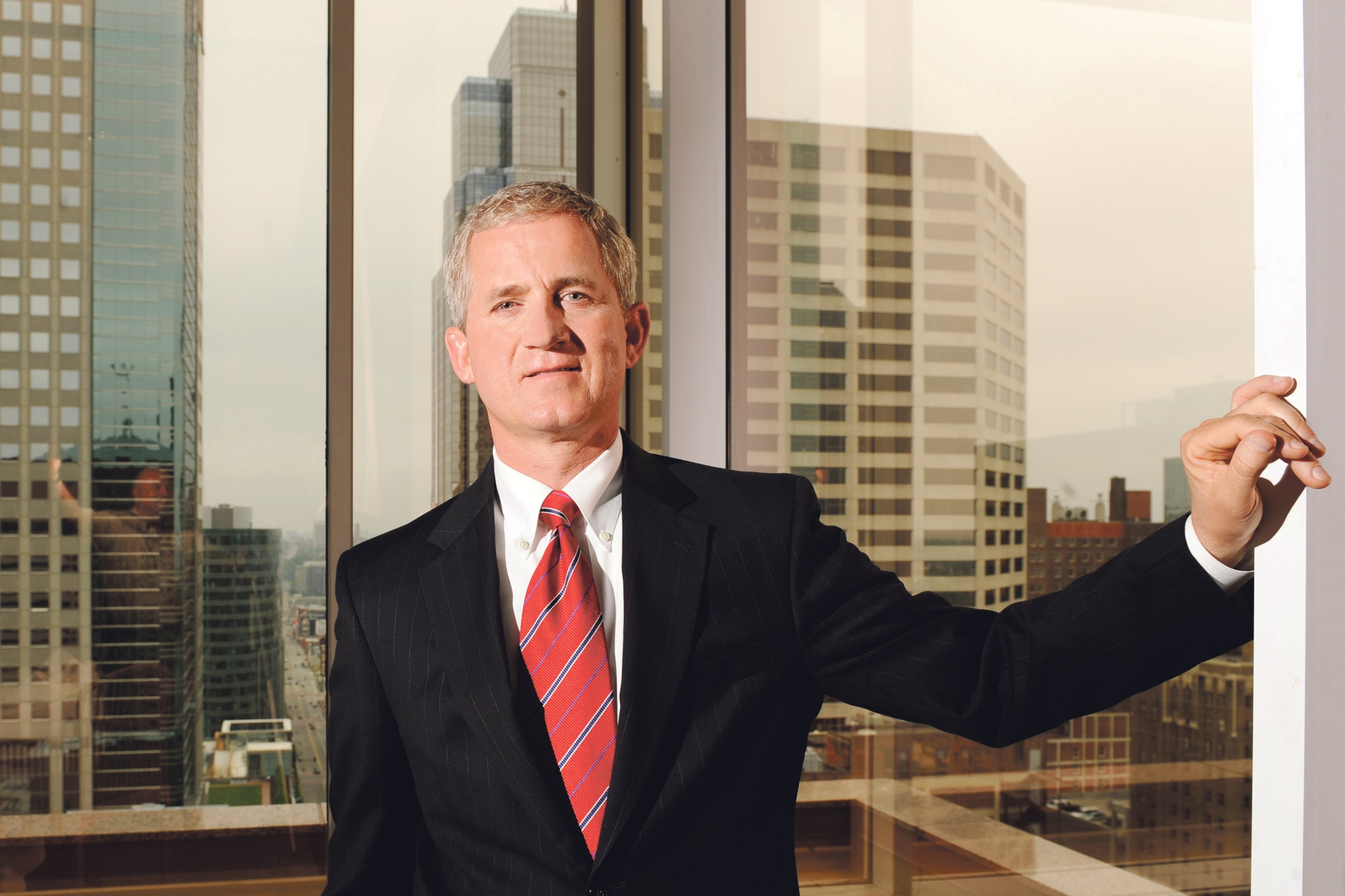 Kevin Barth beside an office window overlooking downtown Kansas City
