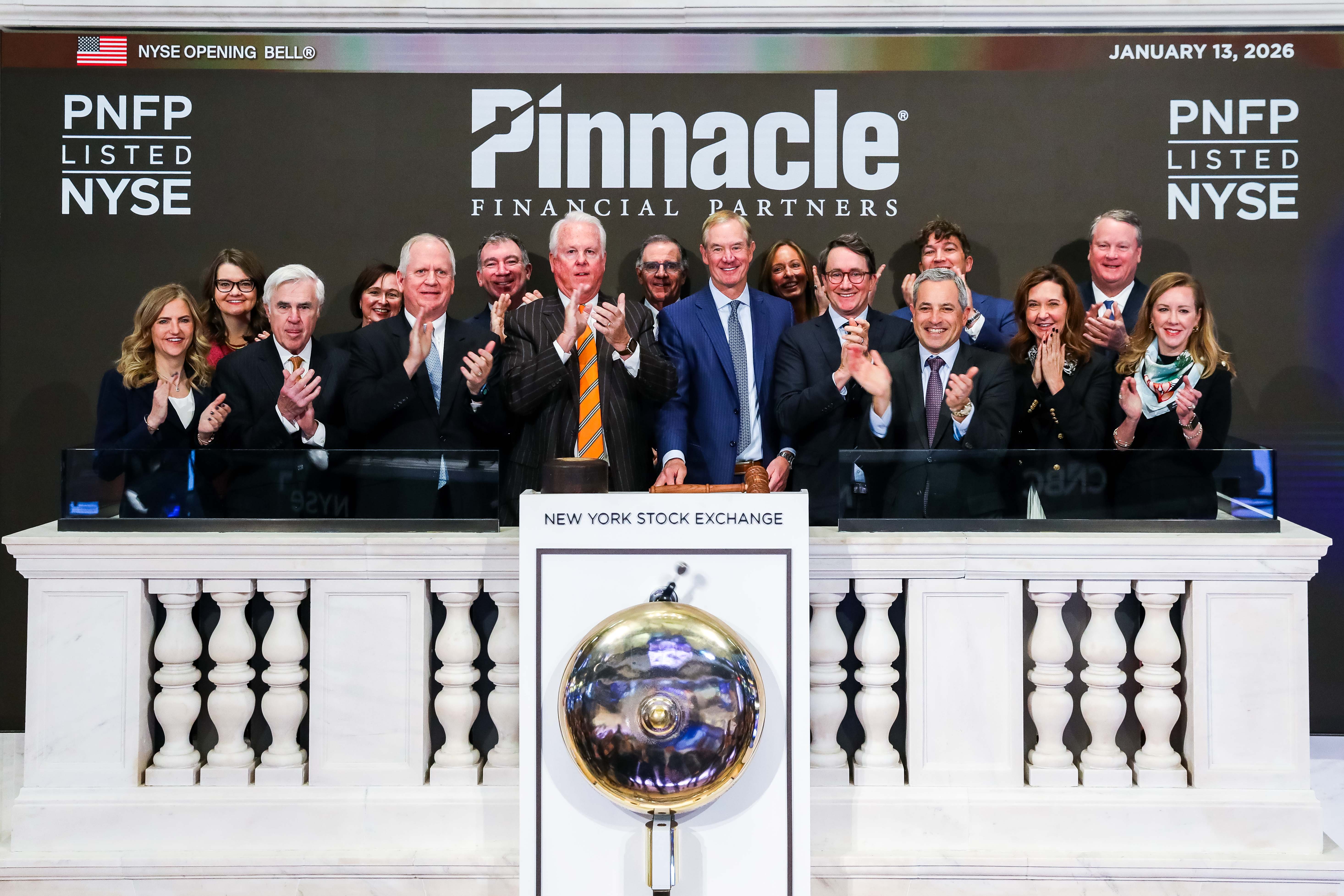 Kevin Blair, at center in a blue suit, joins Pinnacle colleagues on the NYSE opening-bell podium