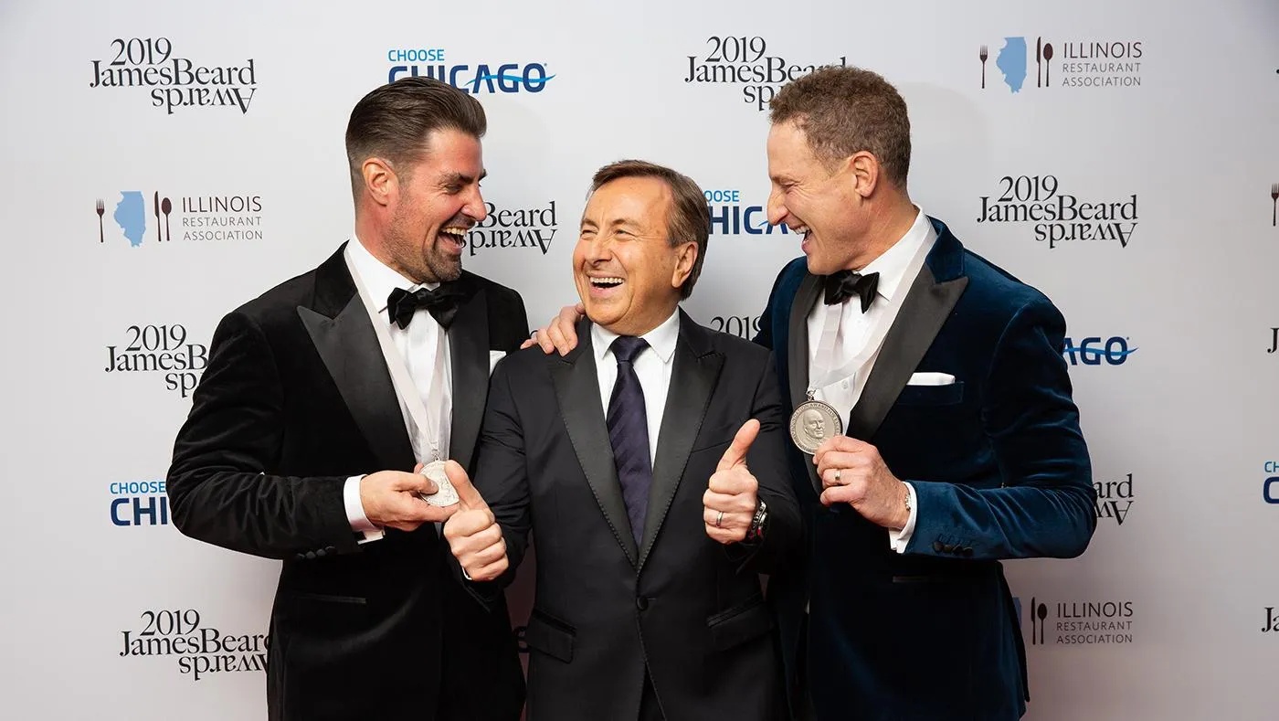 Kevin Boehm, Daniel Boulud and Rob Katz smiling at the 2019 James Beard Awards