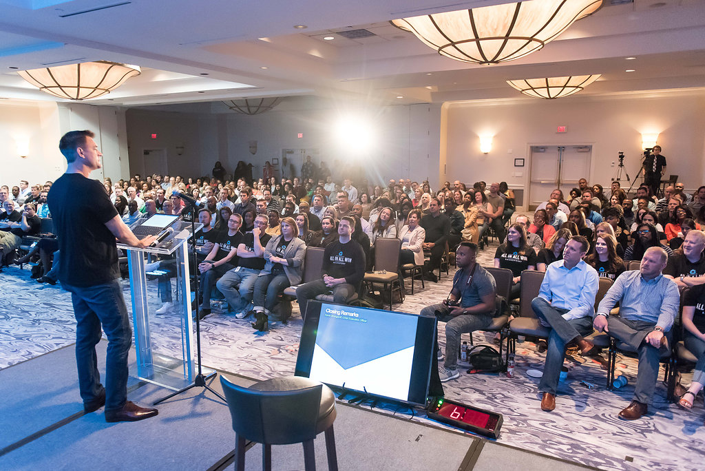 Kevin Brungardt at a lectern addressing a seated audience