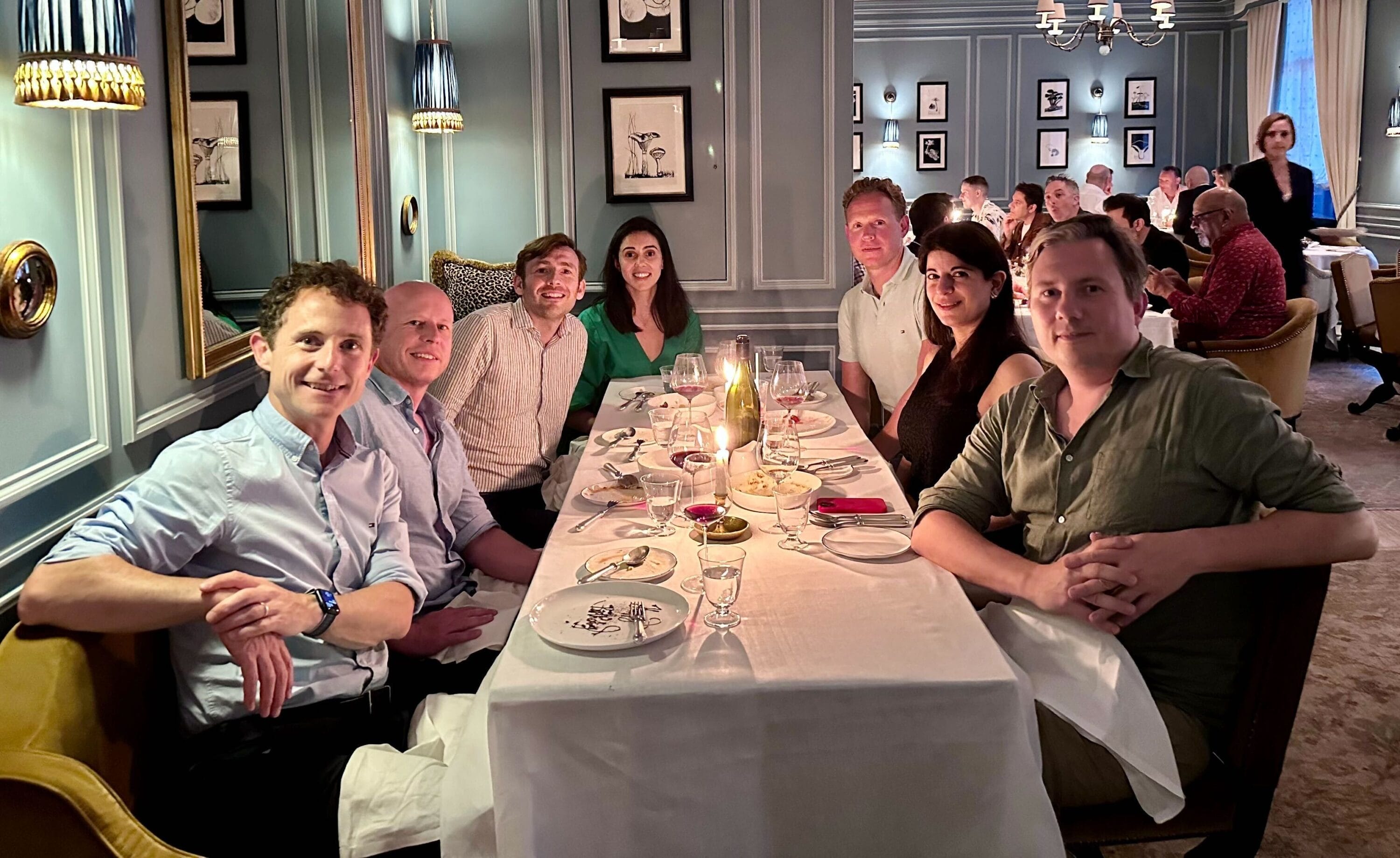 Kevin Cook, third from right, seated around a restaurant table with TreasurySpring colleagues and Balderton investors