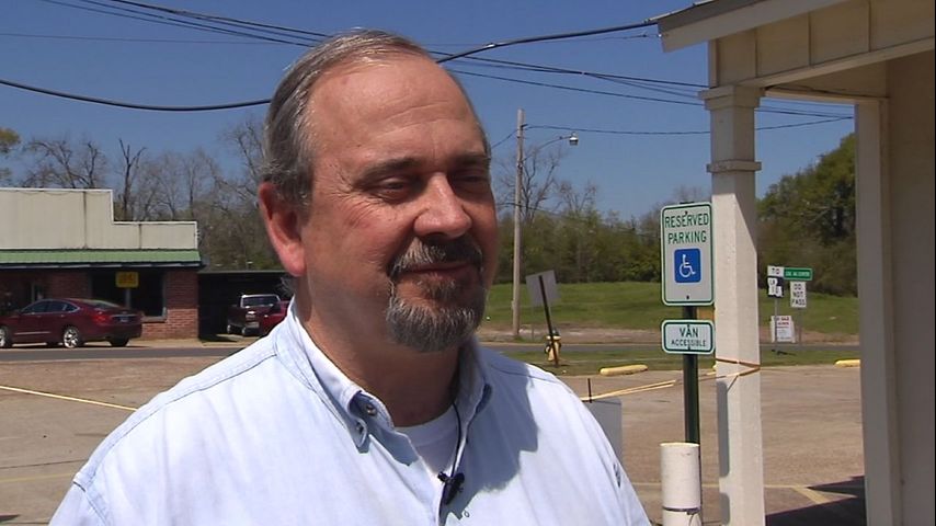 Kevin Couhig speaking outdoors during a television interview