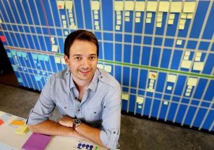 Kevin Eichelberger seated at a desk in an archival Blue Acorn office photograph