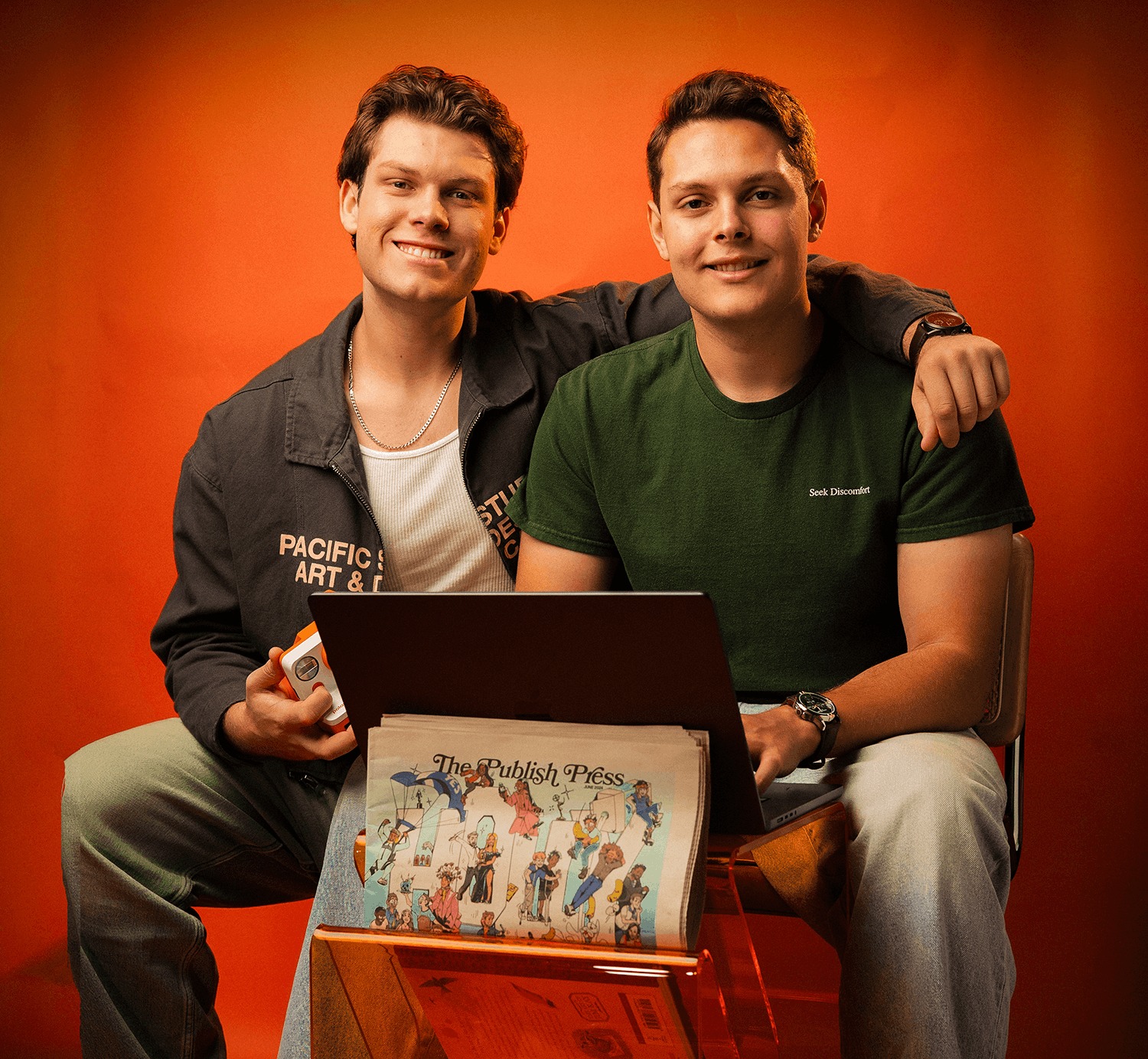 Kevin Figueroa and his brother Ryan seated together against an orange background