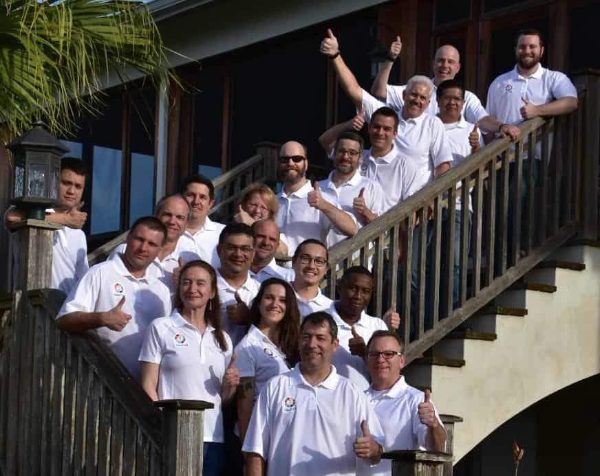 The MyTaskit team gathered on an outdoor staircase, several giving a thumbs-up