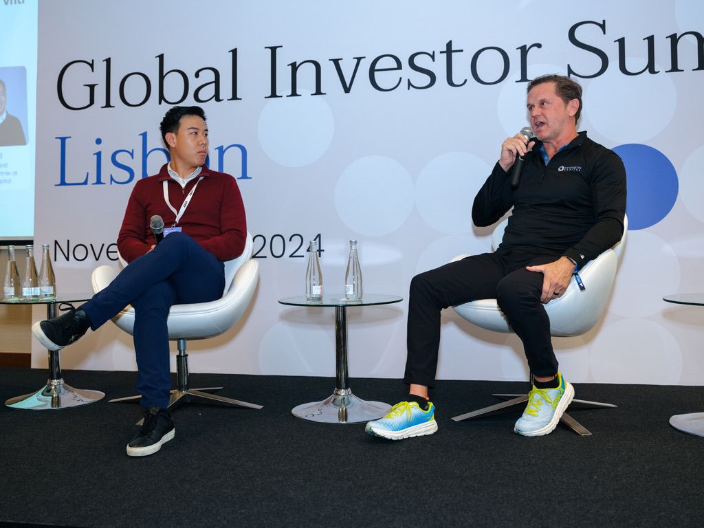Kevin Jiang seated on the left during a discussion at the Global Investor Summit in Lisbon