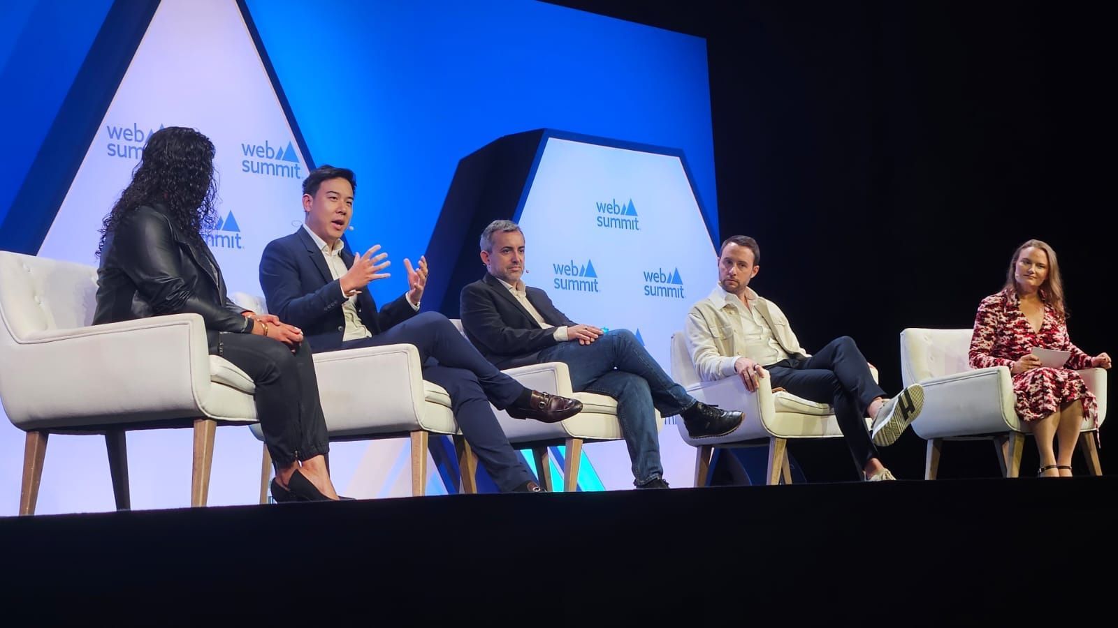 Kevin Jiang on a panel with other speakers on a Web Summit stage
