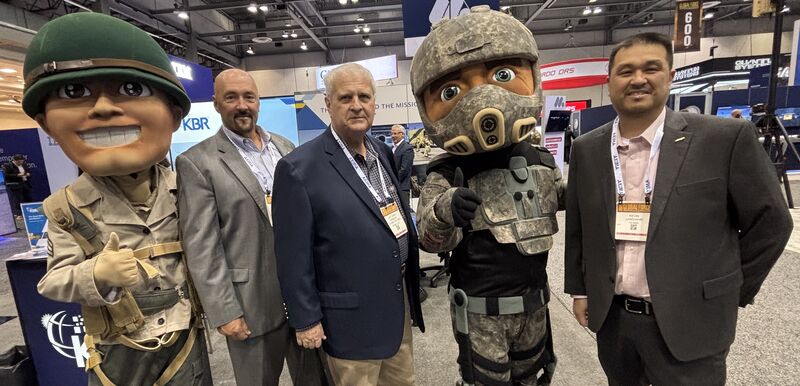 Kevin Langjahr, at far right, with fellow symposium attendees and two military mascots at AUSA Global Force.