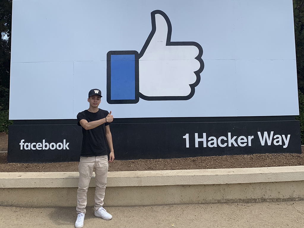 Kevin Leyes standing beside the Facebook sign at 1 Hacker Way