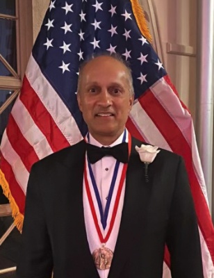 Kevin Lobo in formal dress wearing his Ellis Island Medal of Honor