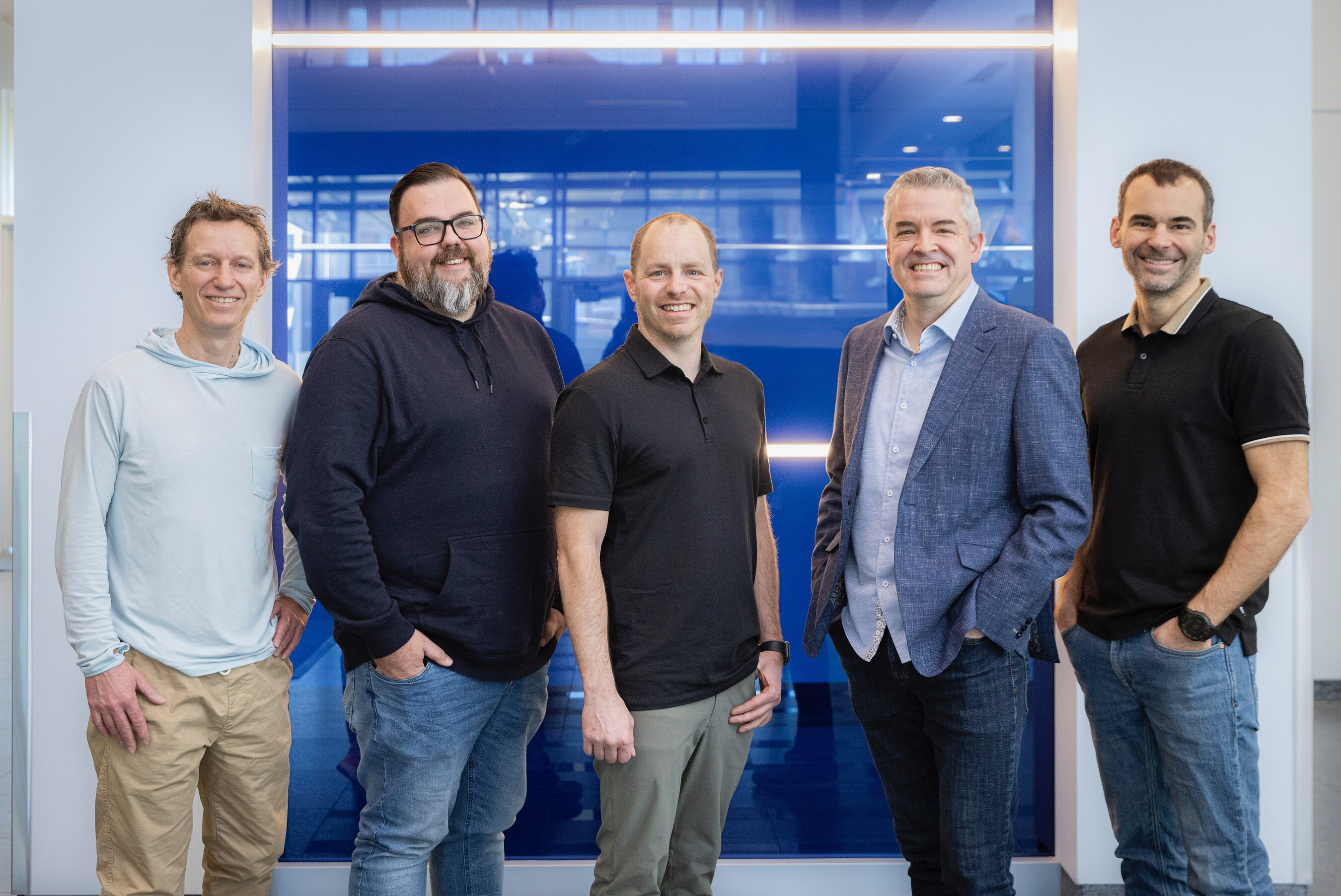 Five executives at the Stratéjia acquisition announcement, with Kevin Moore second from left.