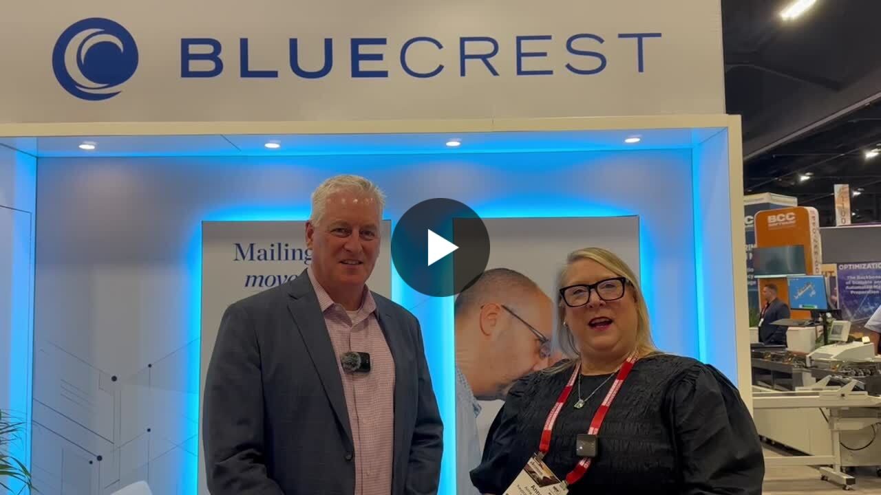 Kevin O'Connor speaking with interviewer Anne Valaitis at the BlueCrest stand during the 2026 National Postal Forum