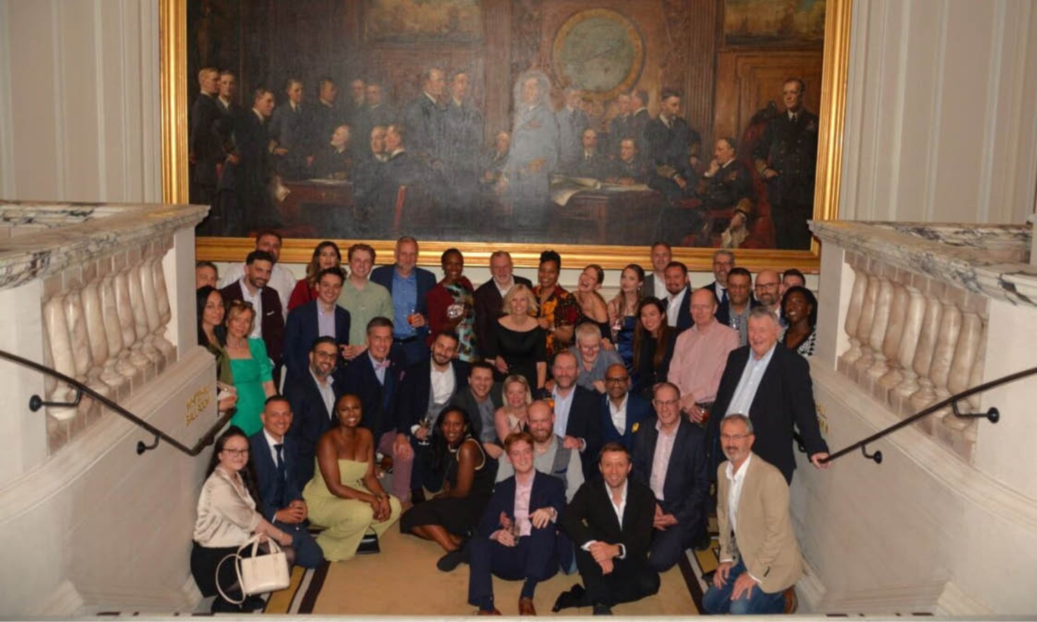 PTS colleagues gathered on an interior staircase