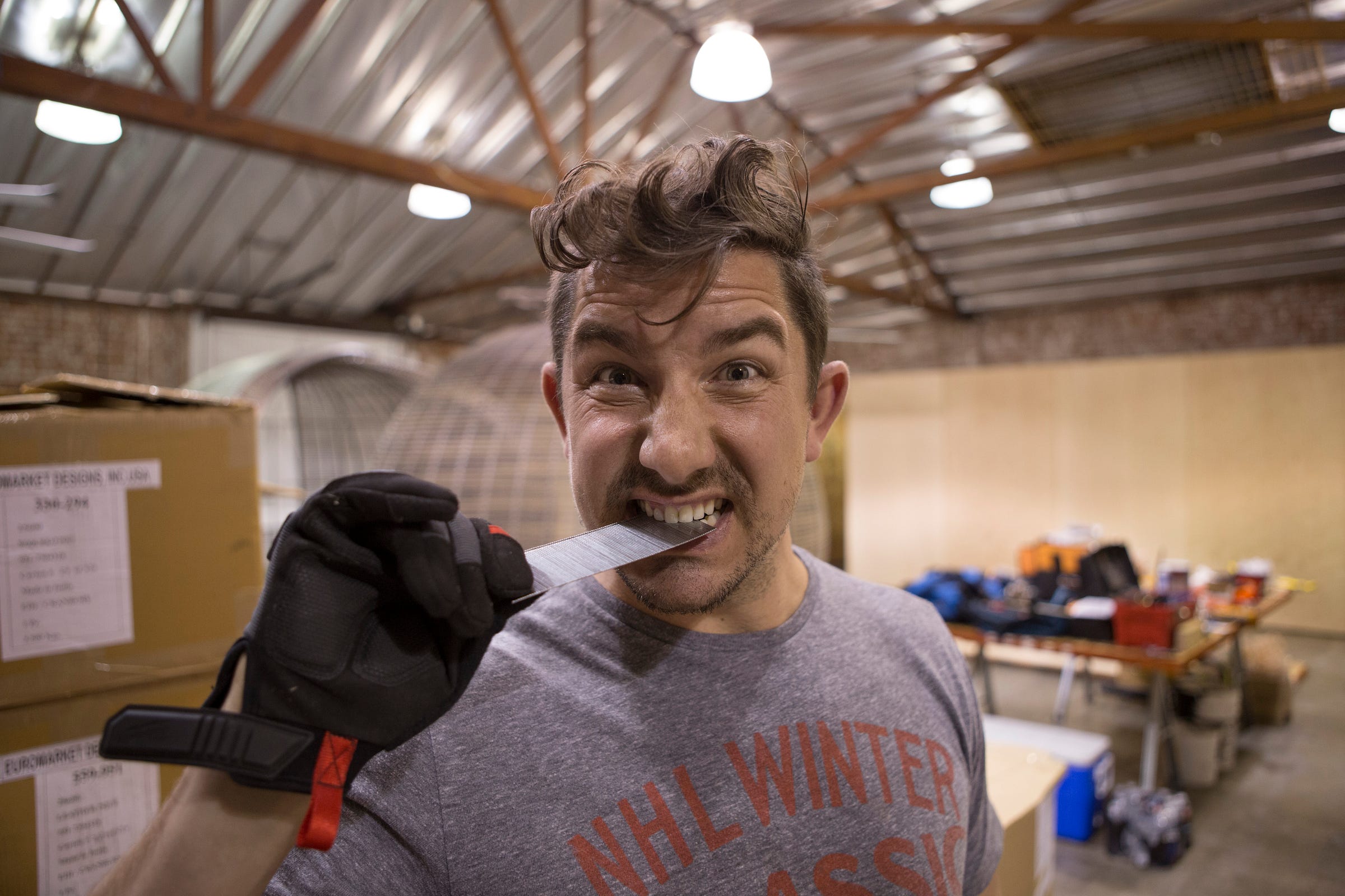 Kevin Williams holding a strip of nails between his teeth during the WC+A office buildout