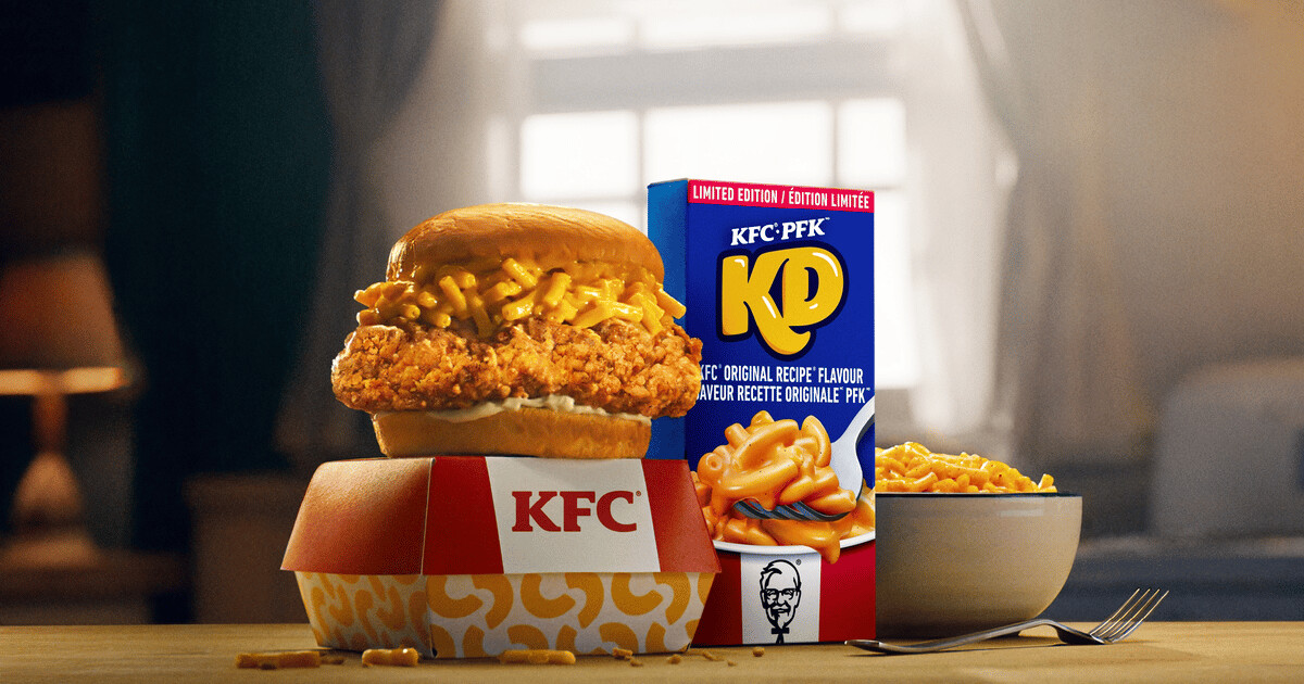 KFC chicken sandwich topped with Kraft Dinner macaroni and cheese beside the co-branded grocery box