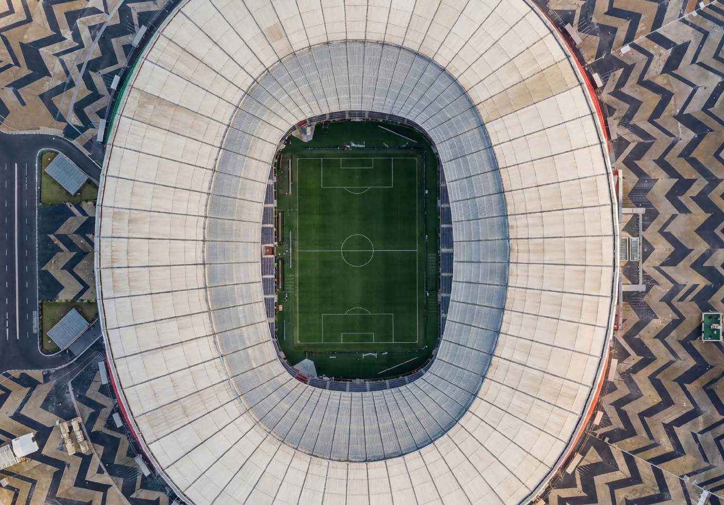 Aerial view of a football stadium with a geometric patterned plaza
