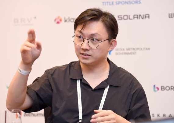Ki Young Ju gesturing during an interview at Korea Blockchain Week 2022