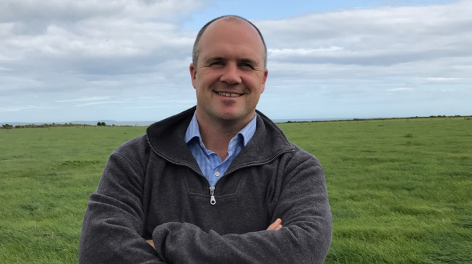 Kieran Furlong standing in a green field in County Wexford, Ireland