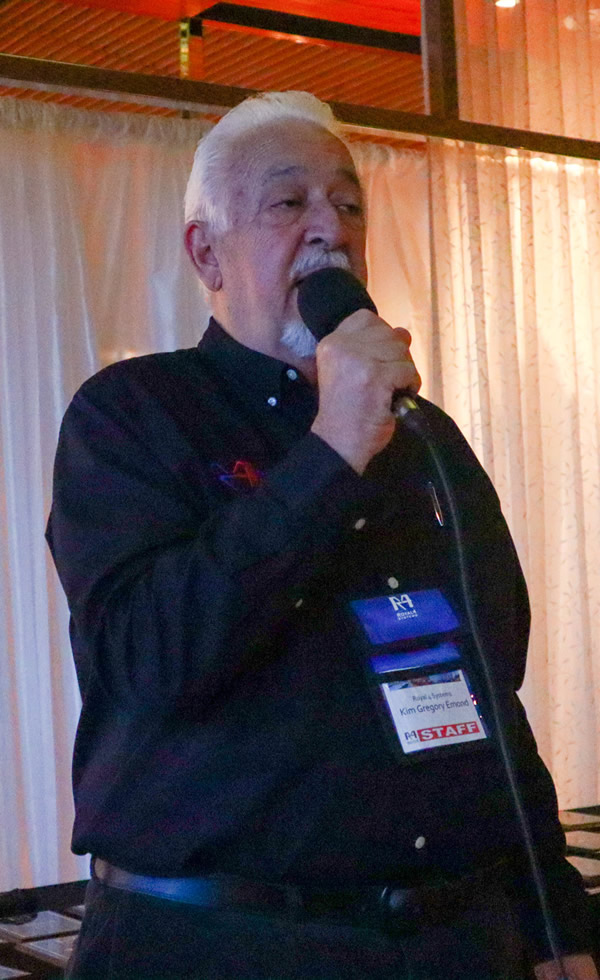 Kim Gregory Emond speaking into a microphone at a Royal 4 event