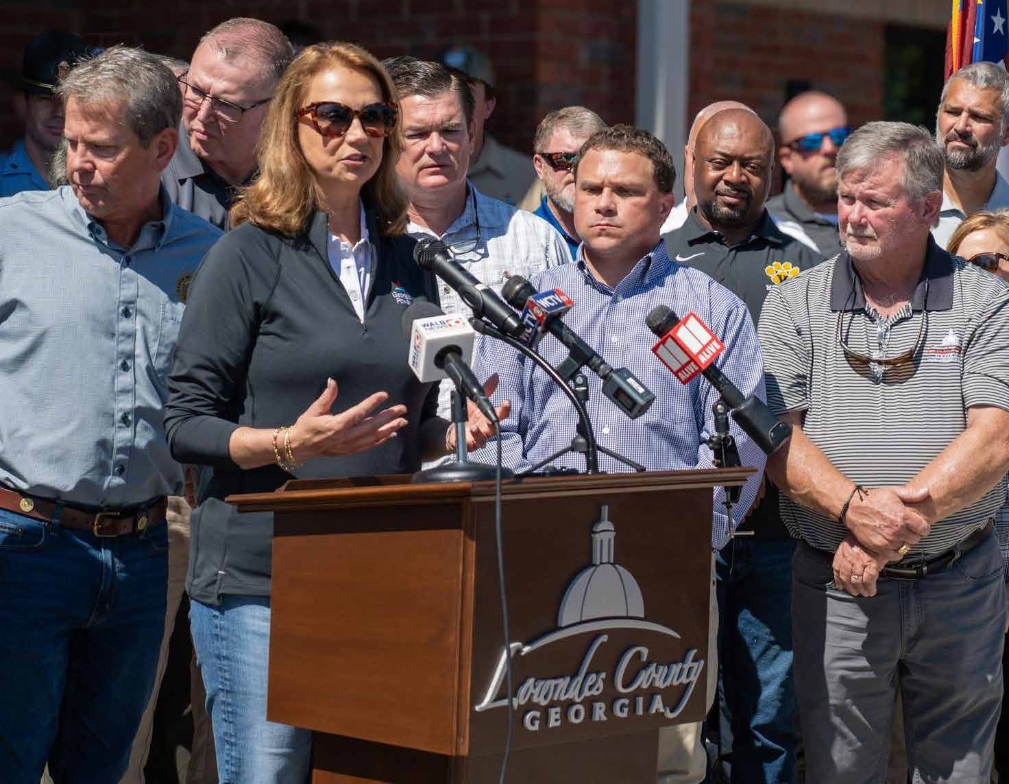 Kim Greene speaking at a Lowndes County outdoor press briefing during the Hurricane Helene response