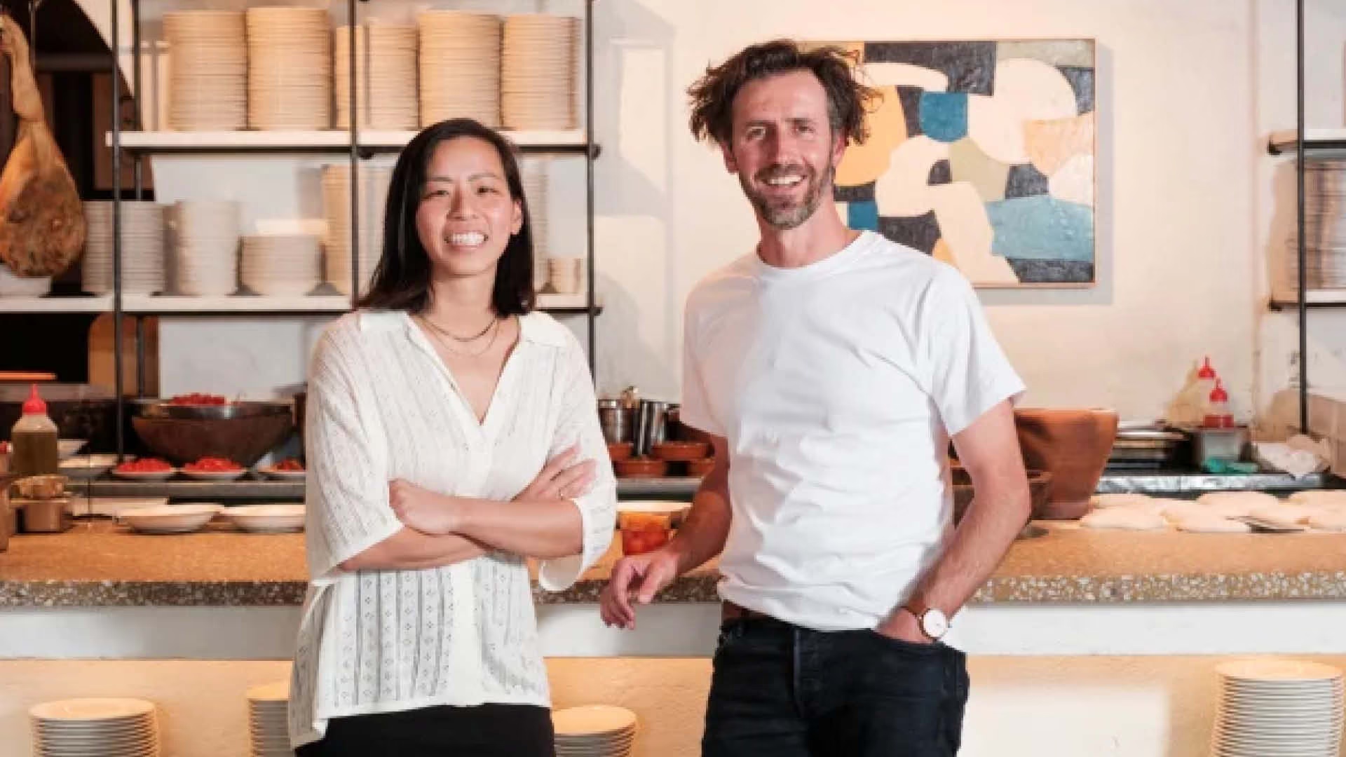 Kim Teo and Stevan Premutico standing together at a restaurant counter