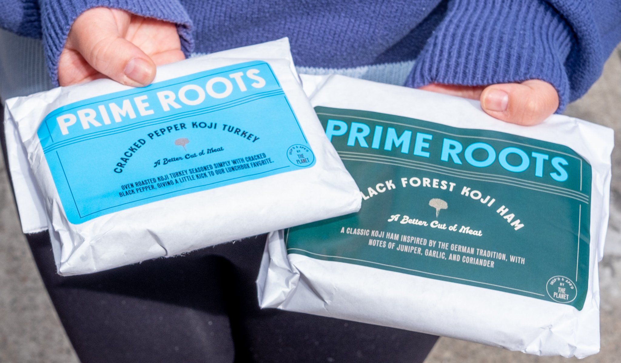 Kimberlie Le holding wrapped Prime Roots cracked pepper koji turkey and Black Forest koji ham