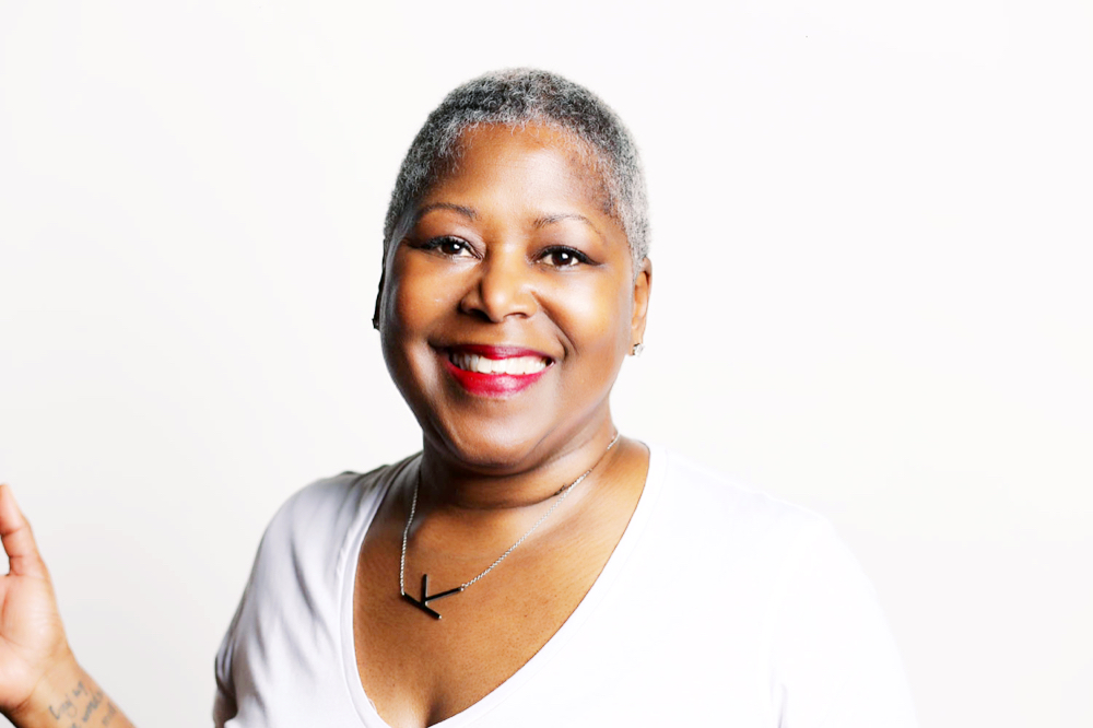 Kimberly Y. Moore smiling in a white top against a light background