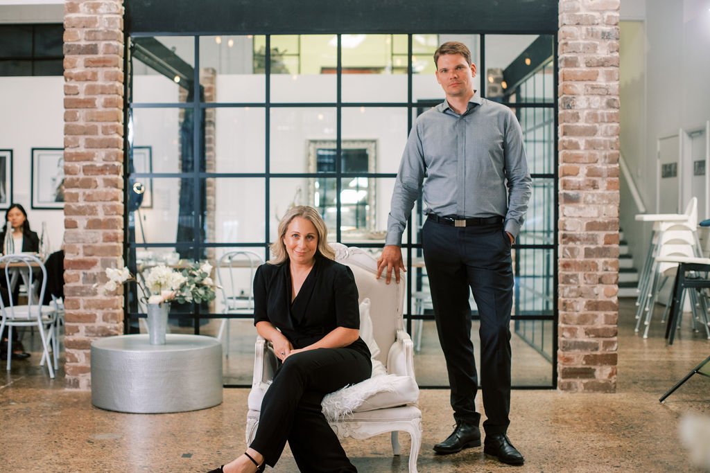 Kimberly Randle seated beside co-founder Dr Arne Geschke in a bright brick-and-glass interior