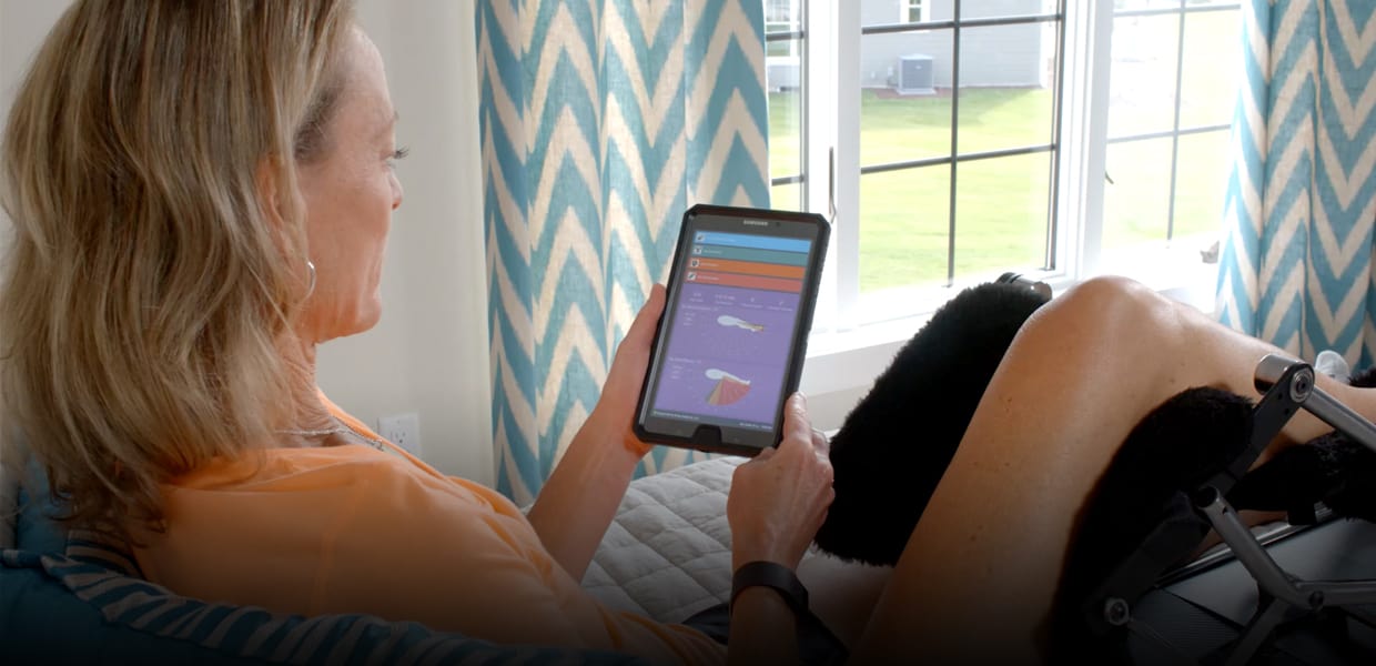 Kinex company photograph showing a patient using home knee rehabilitation equipment