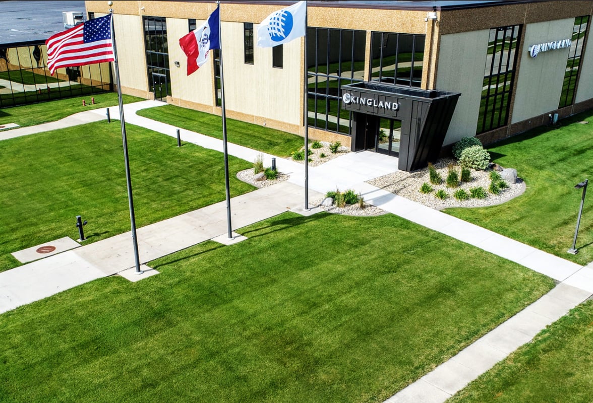 Kingland’s Clear Lake office, with flags and paths across a green lawn