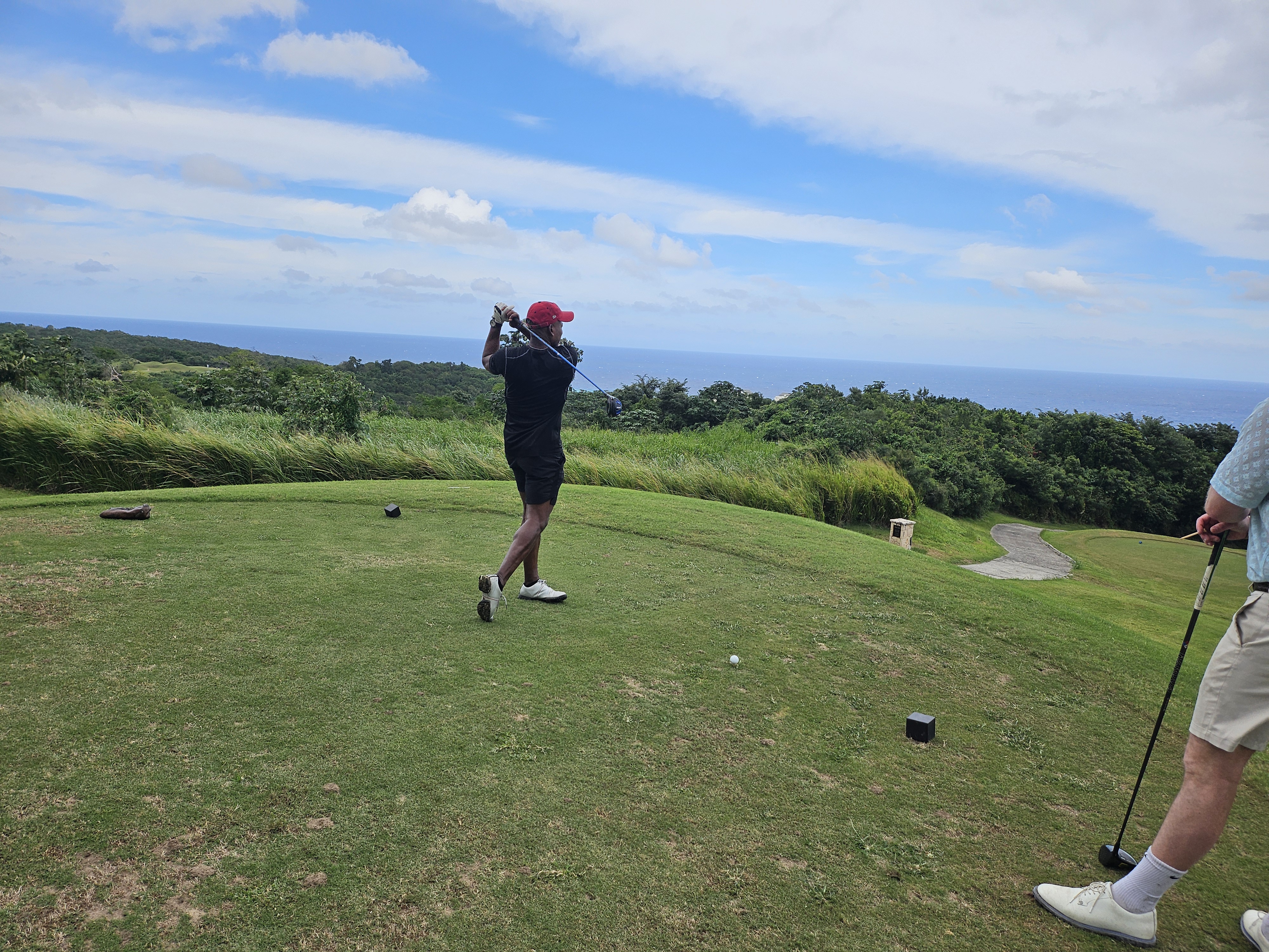 Kingsley Chin playing golf overlooking the sea at White Witch Golf Course in Montego Bay