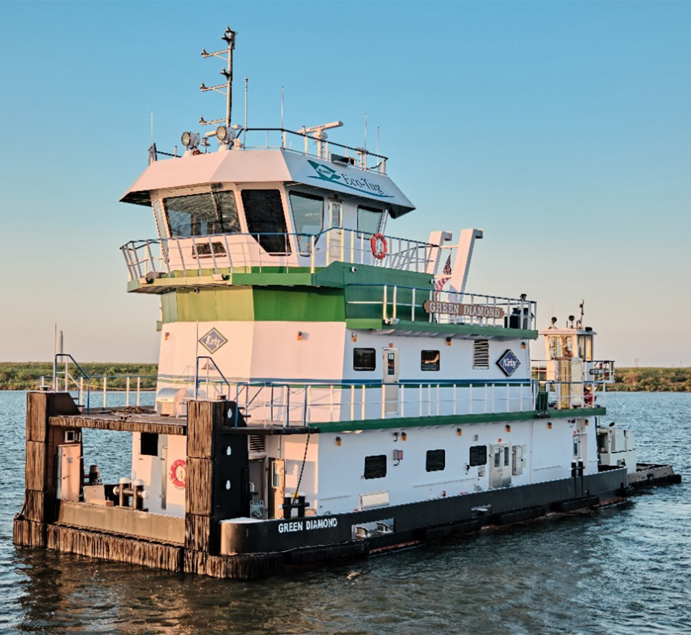 Kirby’s green and white Green Diamond hybrid towboat at a dock