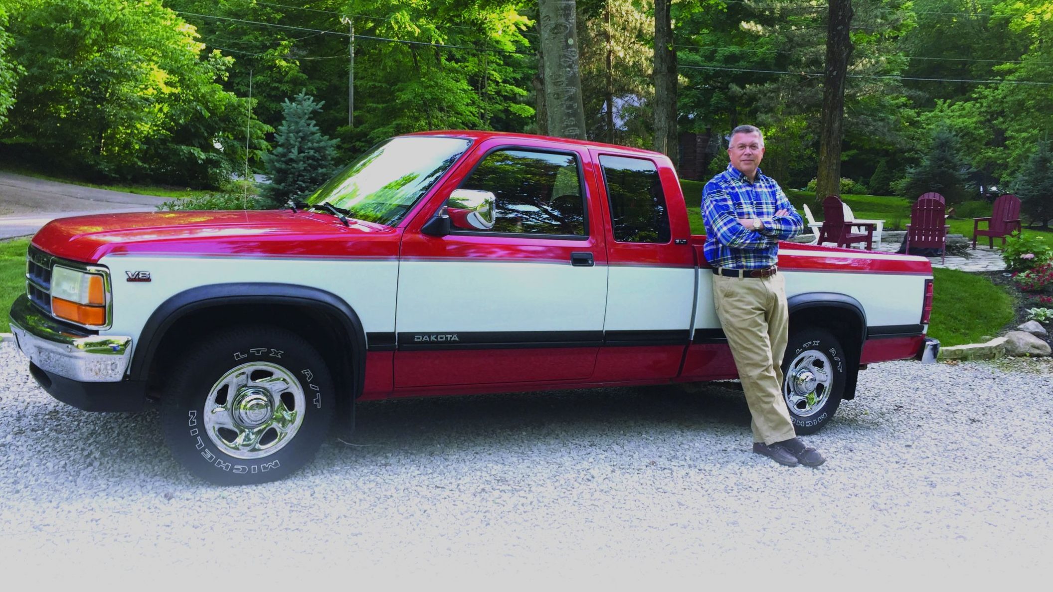 Kirt Walker in a checked shirt beside his father’s red-and-white pickup truck