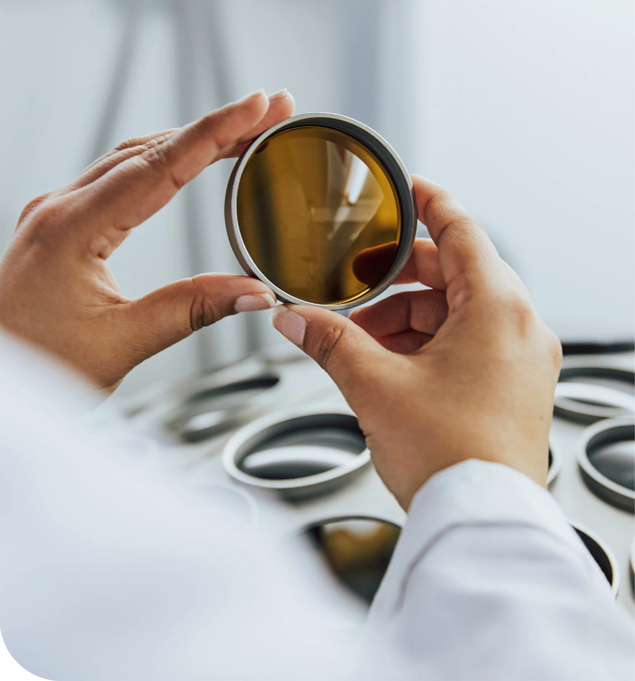 A KITS lab worker inspecting a lens