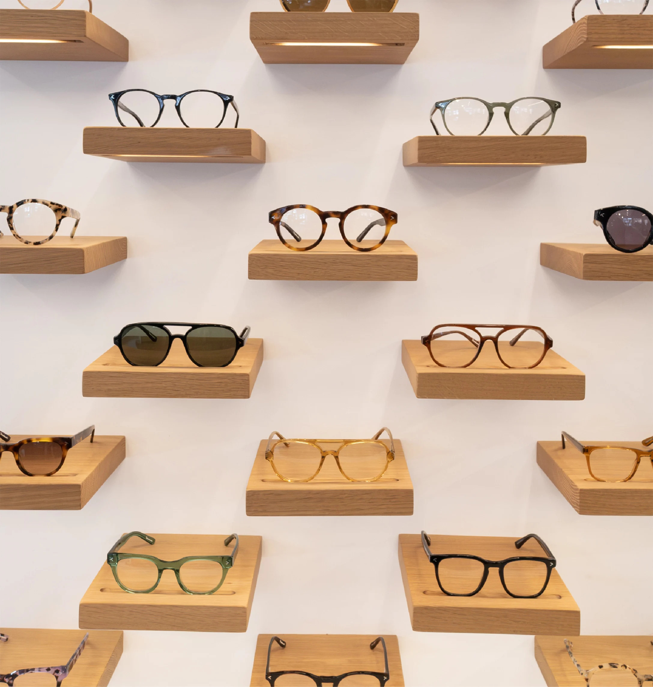 KITS eyeglass frames displayed on wooden shelves