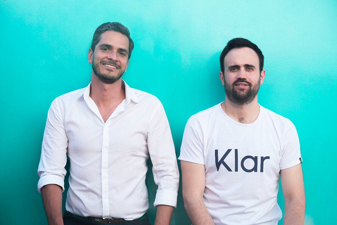 Klar co-founders Stefan Möller and Daniel Autrique photographed against a turquoise wall in 2019