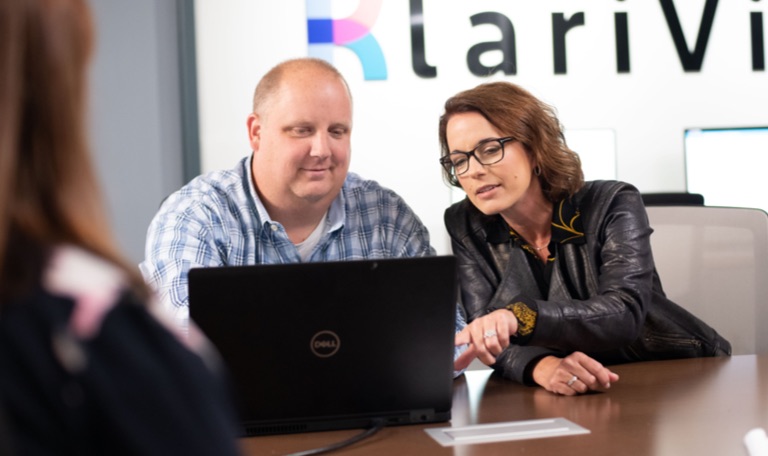 KlariVis founder Kim Snyder and colleague Jerry Bradley looking at a laptop
