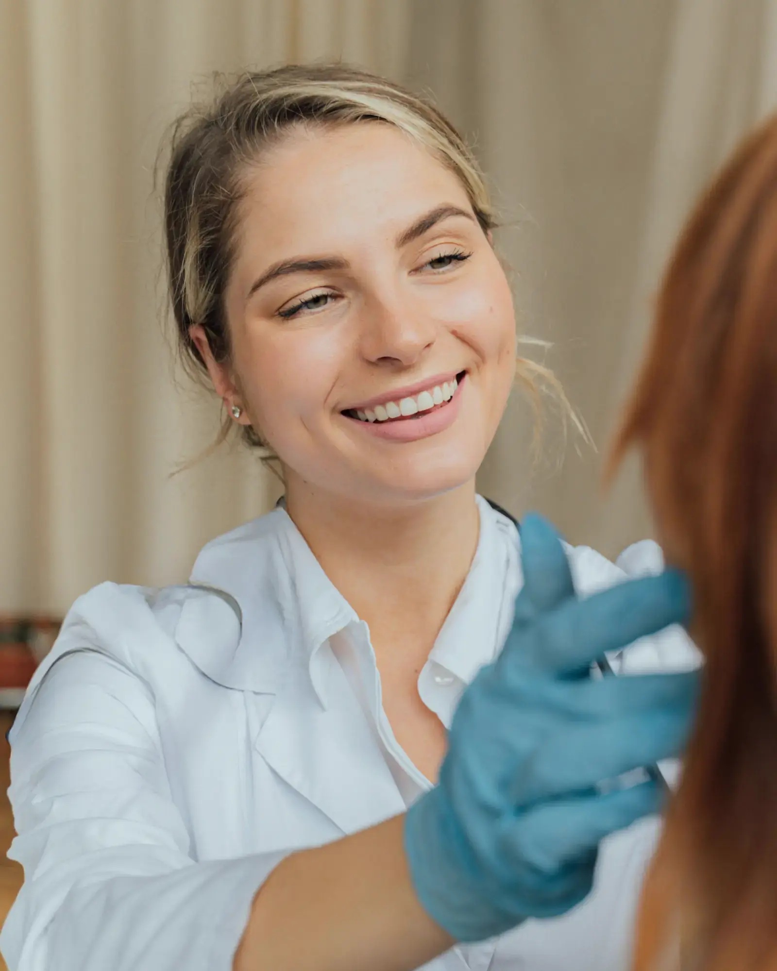 A gloved dental-care professional attending to a patient in Clerri’s marketing photograph
