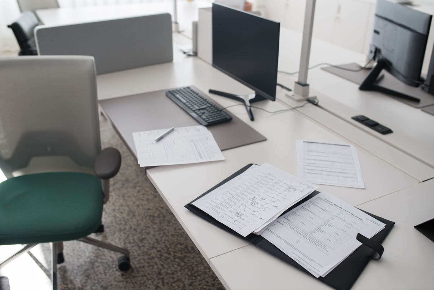 An organized work desk with a binder and documents