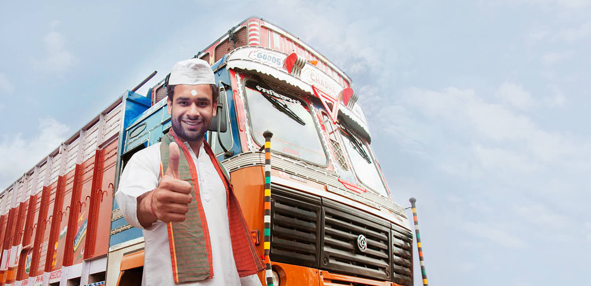 Kogta promotional photograph of a man beside a decorated commercial truck