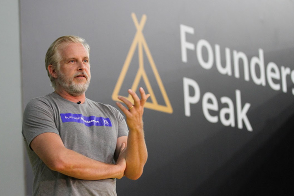 Konstantin Richter speaking and gesturing on the Founders Peak stage
