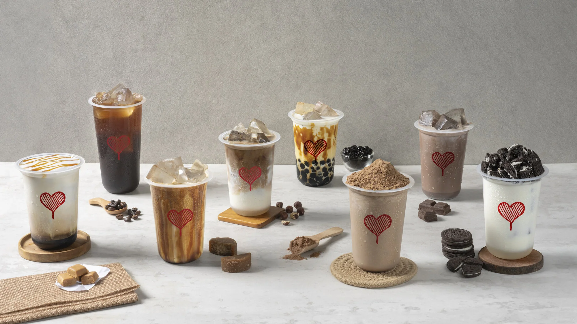 Kopi Kenangan drinks arranged with coffee beans, milk and toppings