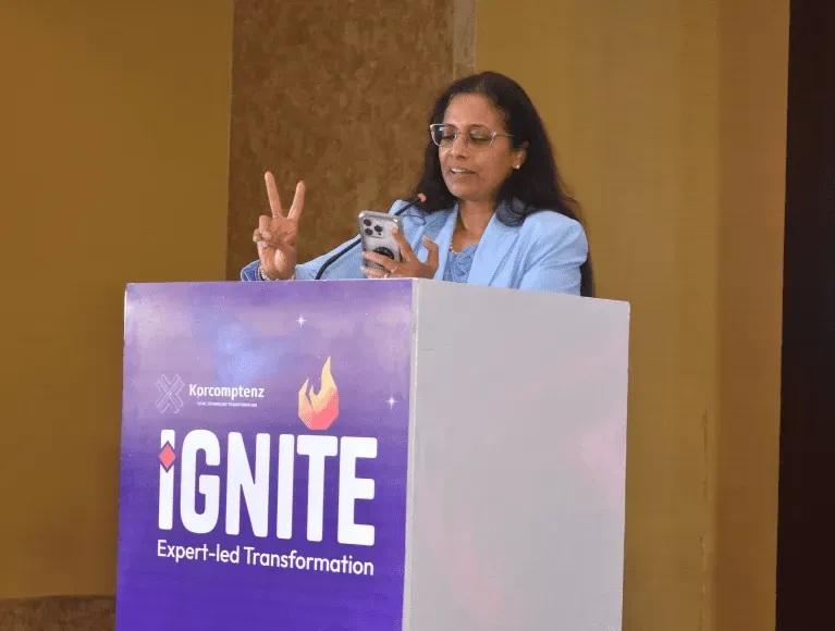 A speaker at a Korcomptenz AI Innovation Center event, behind an Ignite lectern