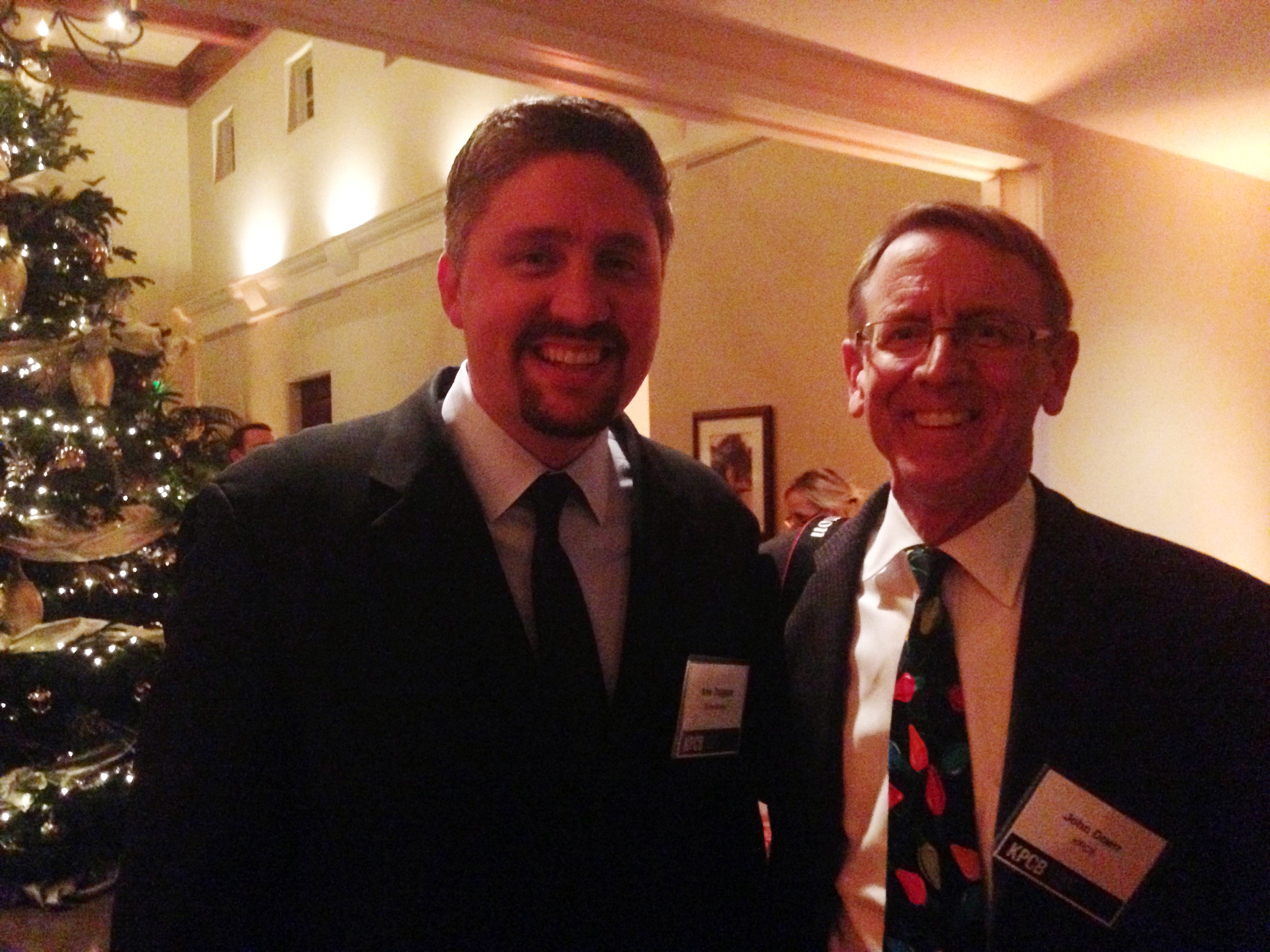 Kris Duggan, left, and John Doerr smiling at a holiday party