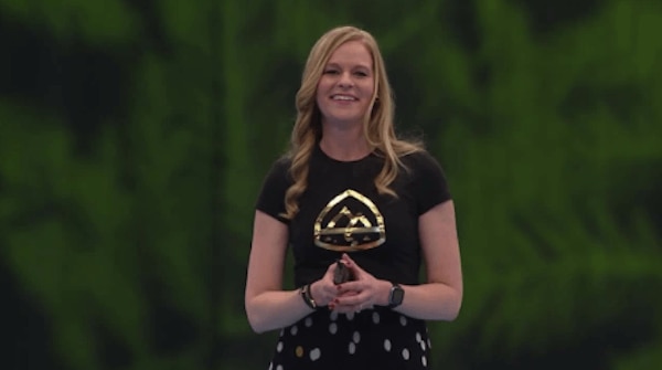 Kris Lande speaking onstage at a Salesforce event